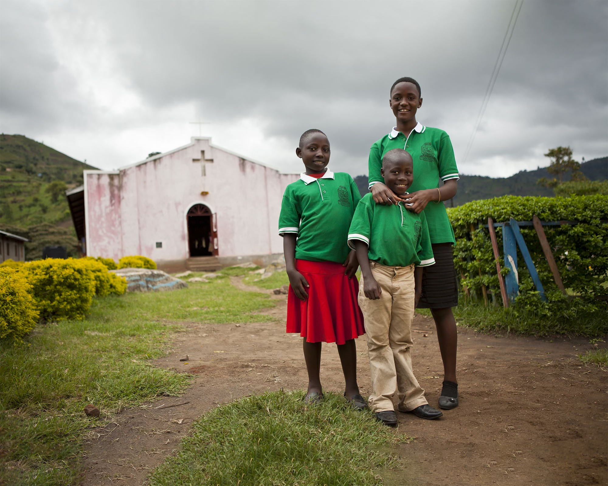 Three children stood outside their church smiling